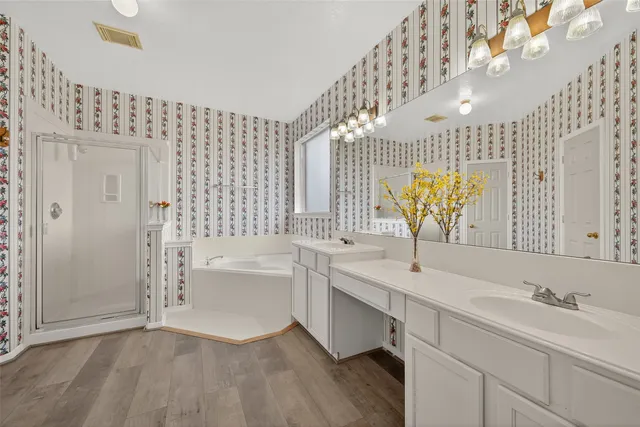 a bathroom with a sink a bathtub and a shower