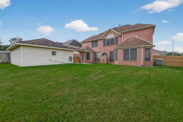 a view of a house with a yard and a porch