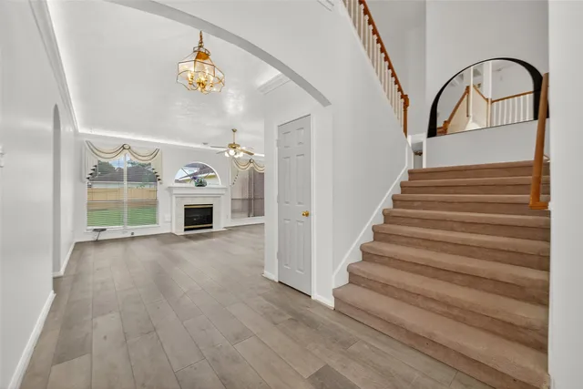 a view of entryway and hall with wooden floor