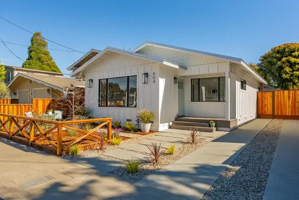 a view of a house with dining room and wooden fence