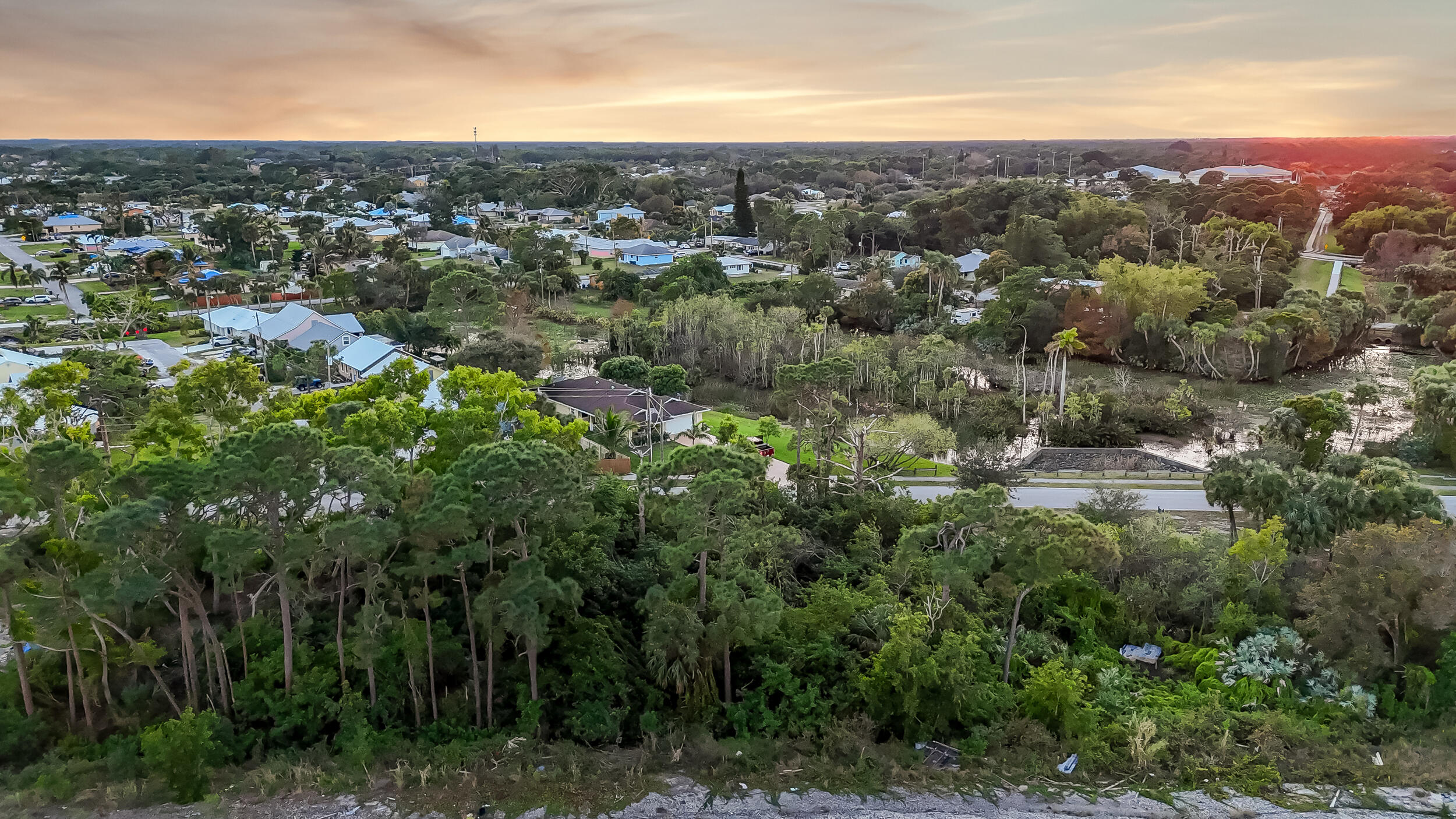 4959 Southeast Primrose Way Stuart, FL 34997 - Photo 11 of 12 an aerial view of residential houses with outdoor space and trees