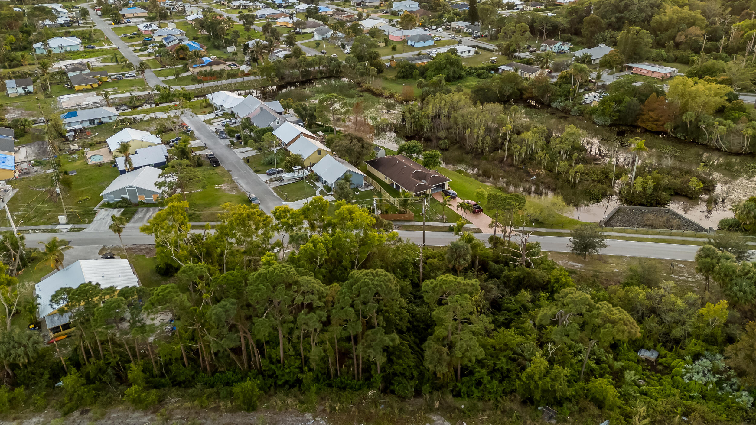 4959 Southeast Primrose Way Stuart, FL 34997 - Photo 6 of 12 an aerial view of residential houses with outdoor space and trees