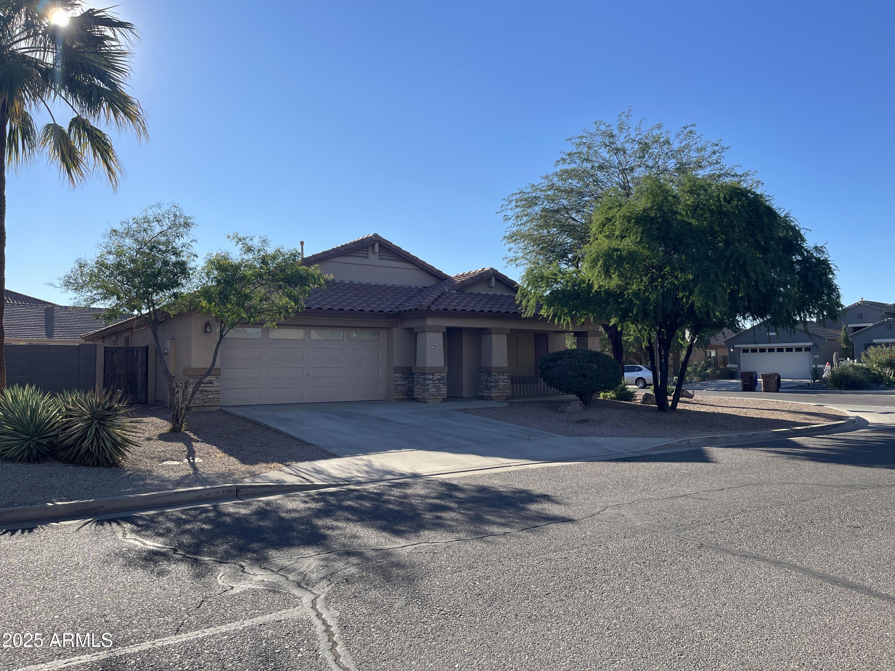 29062 North Mountain View Road San Tan Valley, AZ 85143 - Photo 16 of 16 a front view of a house with a yard and garage