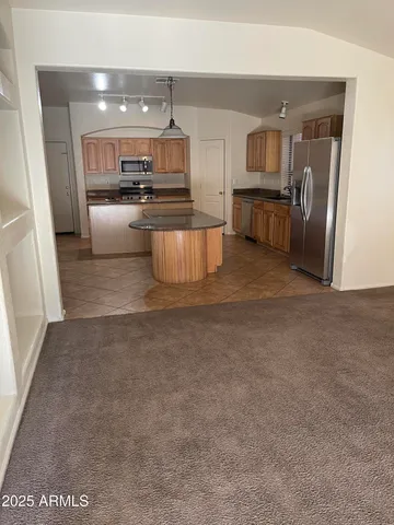a large kitchen with cabinets and stainless steel appliances