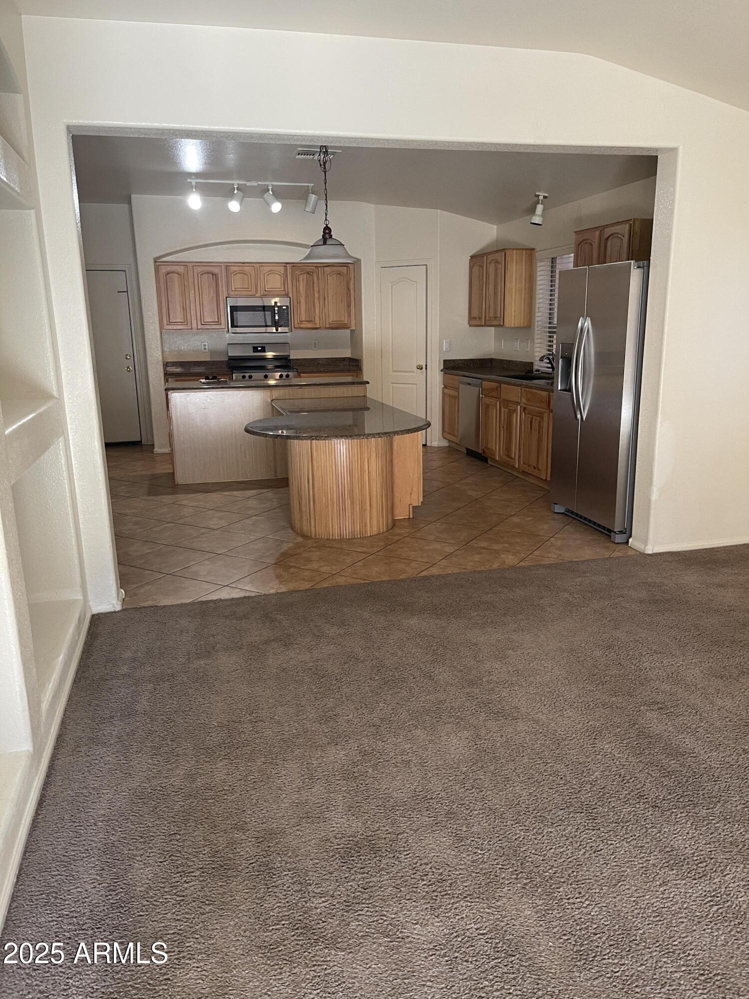 29062 North Mountain View Road San Tan Valley, AZ 85143 - Photo 5 of 16 a large kitchen with cabinets and stainless steel appliances