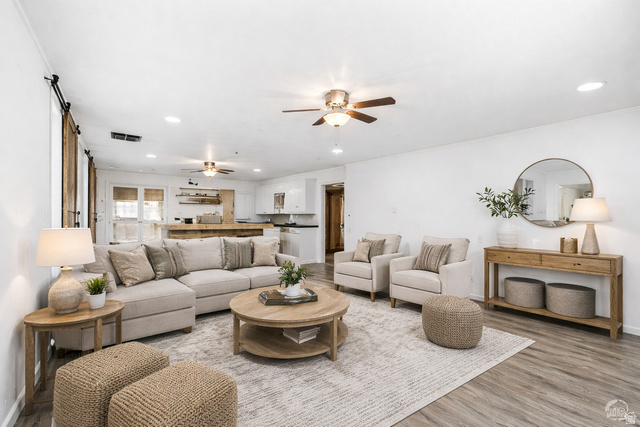 25615 Main Street Portage, UT 84331 - Photo 6 of 42 Living room with a ceiling fan, recessed lighting, light wood-style floors, and a barn door