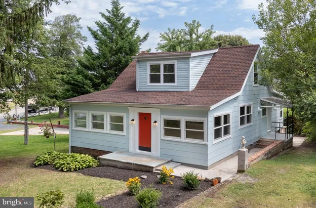 a front view of a house with a garden and plants