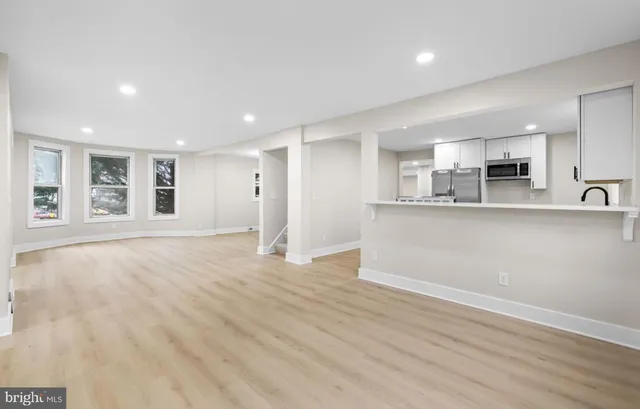 a large kitchen with a table and chairs