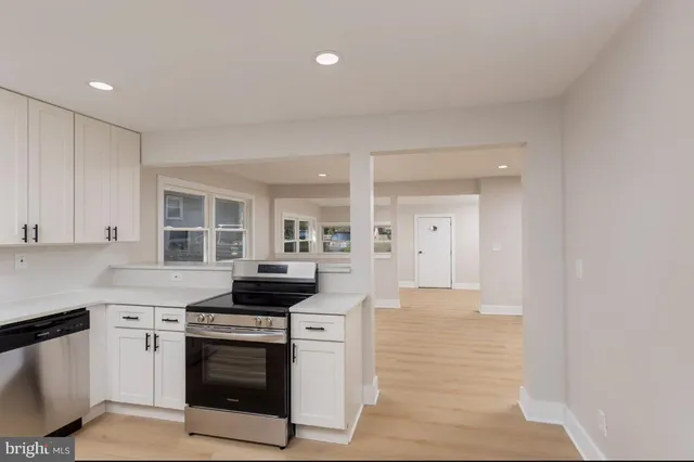a kitchen with stainless steel appliances granite countertop a stove and a sink