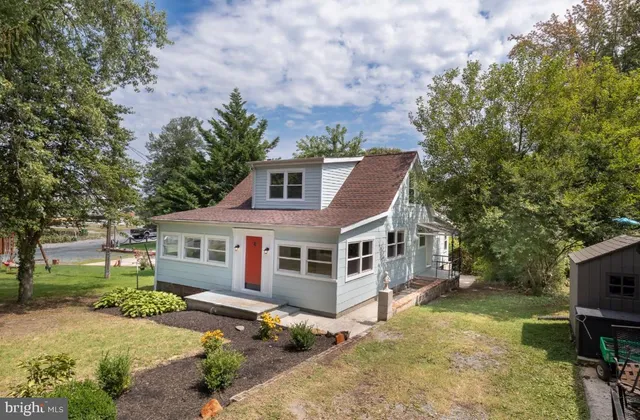 a front view of a house with a yard table and chairs