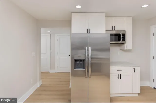 a view of a kitchen with a closet and electronic appliances