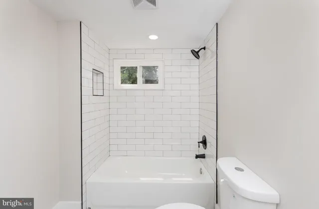 a bathroom with a bathtub and shower