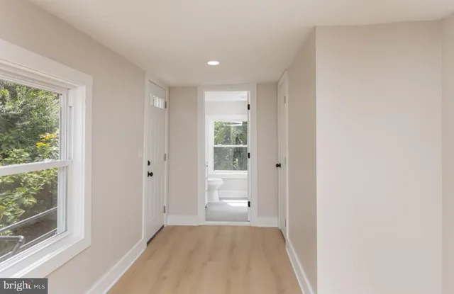 a view of a livingroom with an empty space and a window