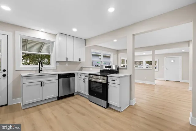 a kitchen with stainless steel appliances granite countertop a stove a refrigerator and a microwave