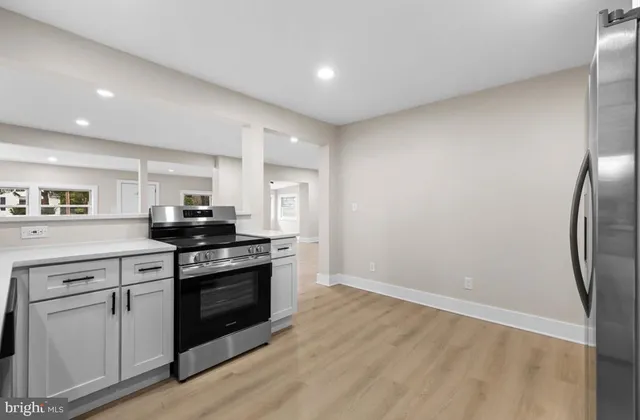 a metallic refrigerator freezer sitting in a kitchen
