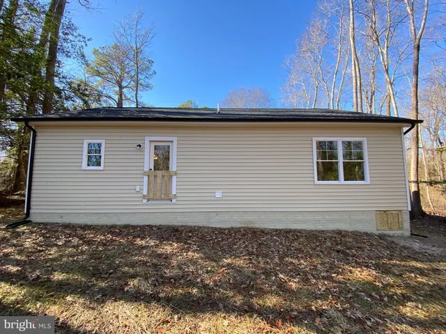 a side view of a house with a yard
