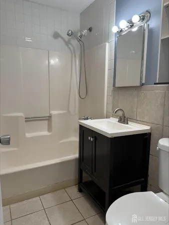 a bathroom with a sink vanity toilet and bathtub