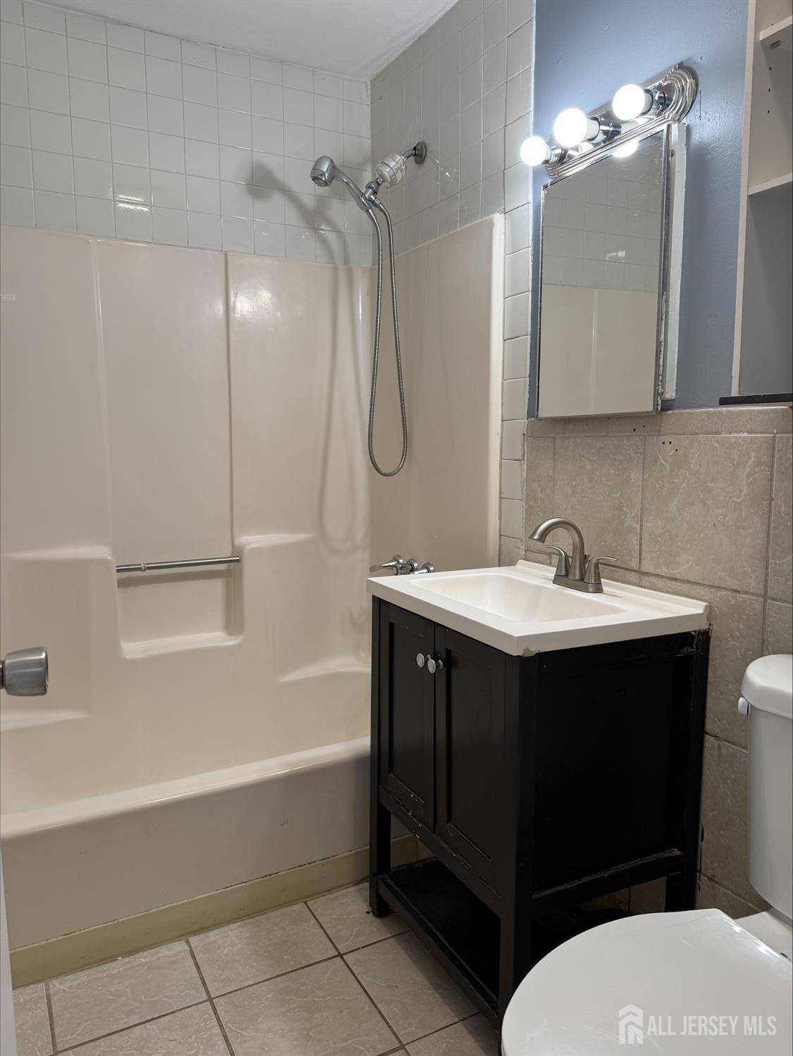 1211 Stelton Road Piscataway, NJ 08854 - Photo 13 of 16 a bathroom with a sink vanity toilet and shower