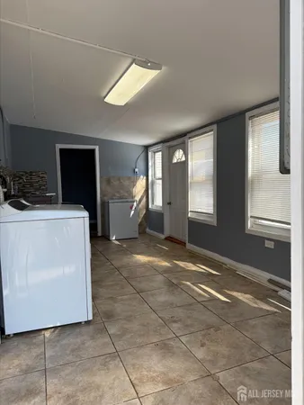 a view of a livingroom with furniture and a window