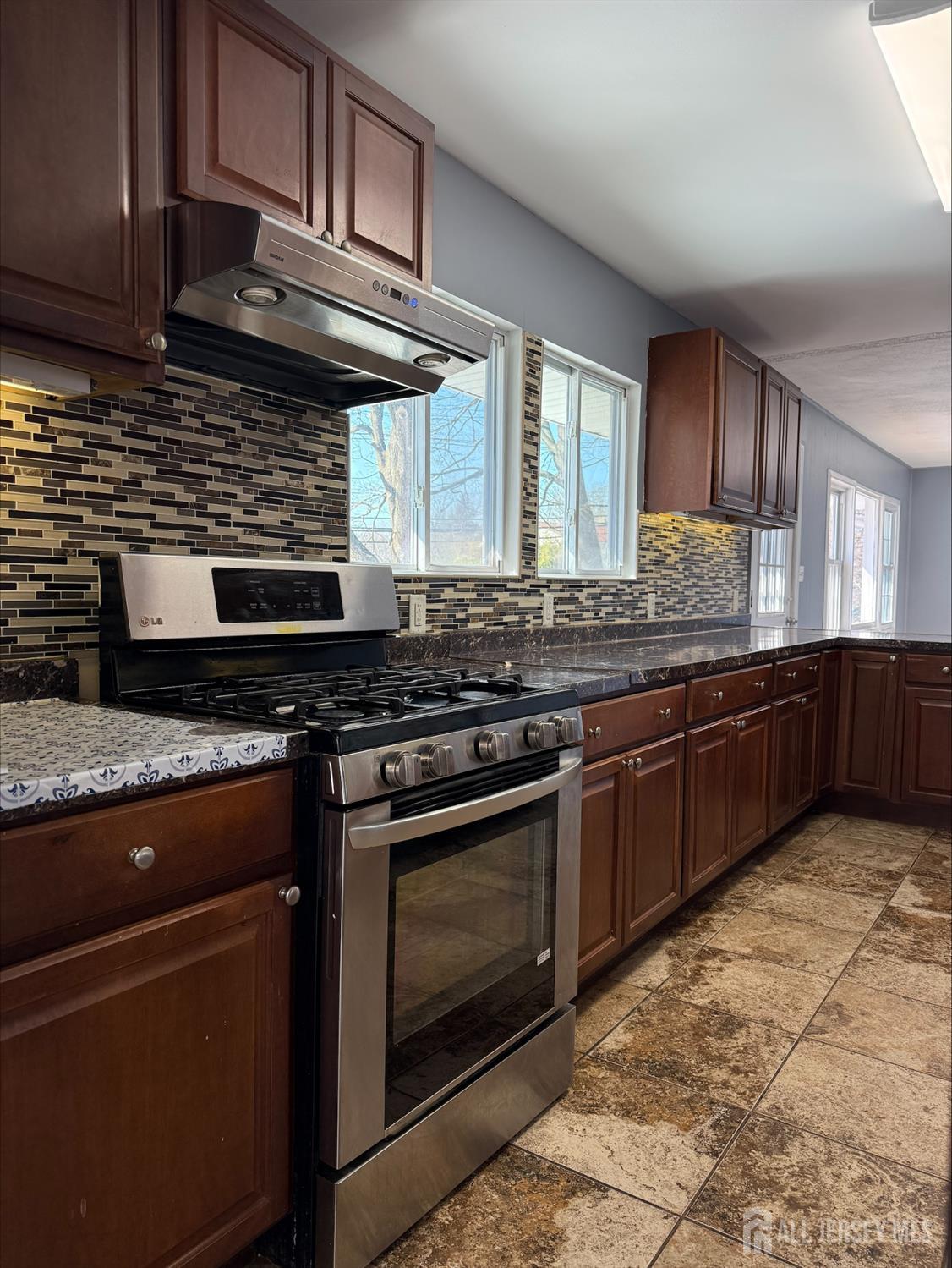 1211 Stelton Road Piscataway, NJ 08854 - Photo 5 of 16 a kitchen with stainless steel appliances granite countertop a stove and a sink