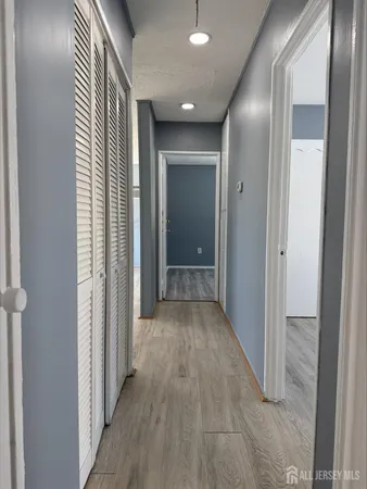 a view of a hallway with wooden floor
