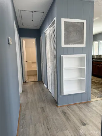 an empty room with cabinet and windows