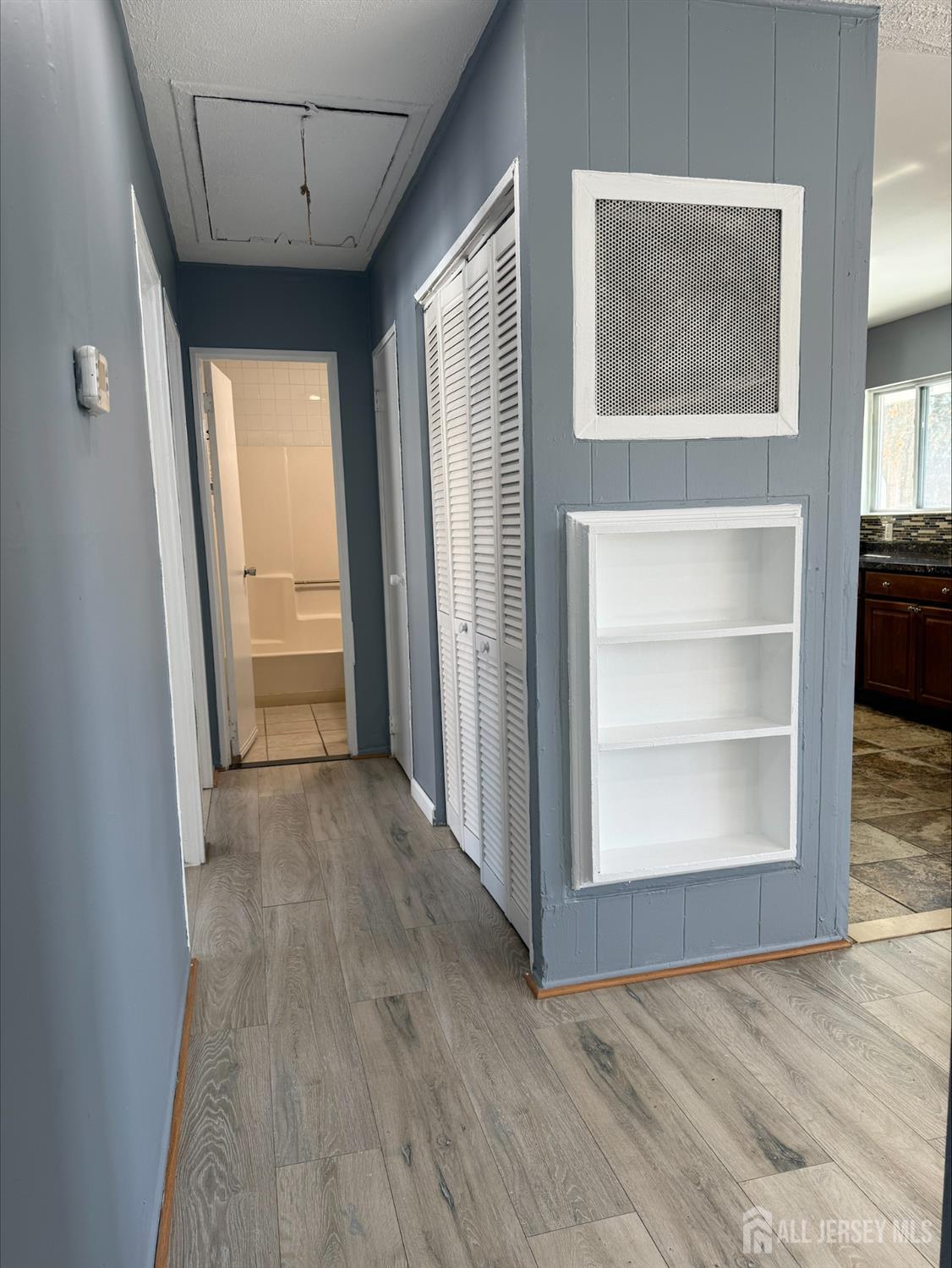 1211 Stelton Road Piscataway, NJ 08854 - Photo 8 of 16 an empty room with cabinet and windows