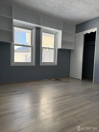 an empty room with windows and closet