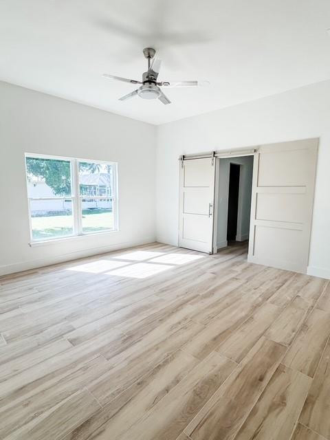 1445 Southeast 23rd Street Okeechobee, FL 34974 - Photo 8 of 11 a view of empty room with wooden floor and fan