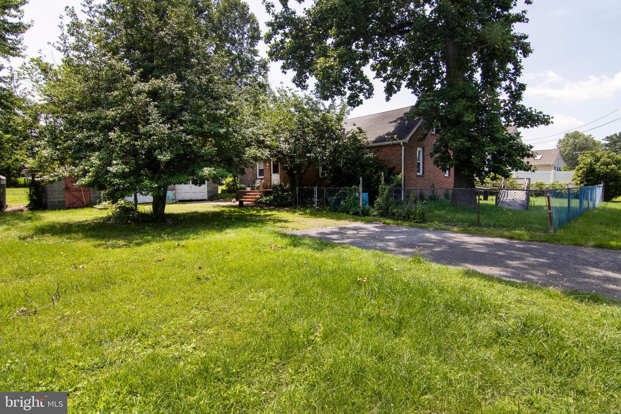 266 Passaic Avenue Thorofare, NJ 08086 - Photo 22 of 53 a view of a swimming pool with a bench and trees