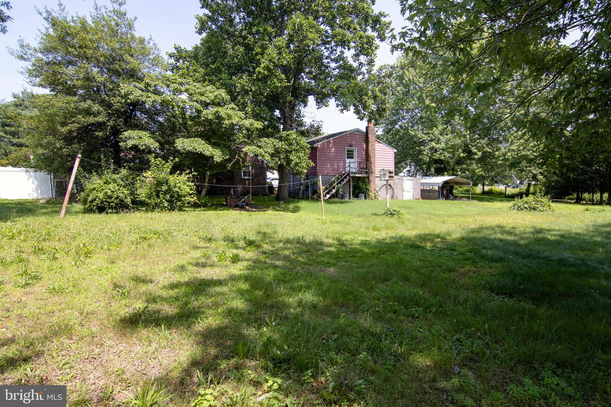 266 Passaic Avenue Thorofare, NJ 08086 - Photo 43 of 53 a yellow house in middle of the green field