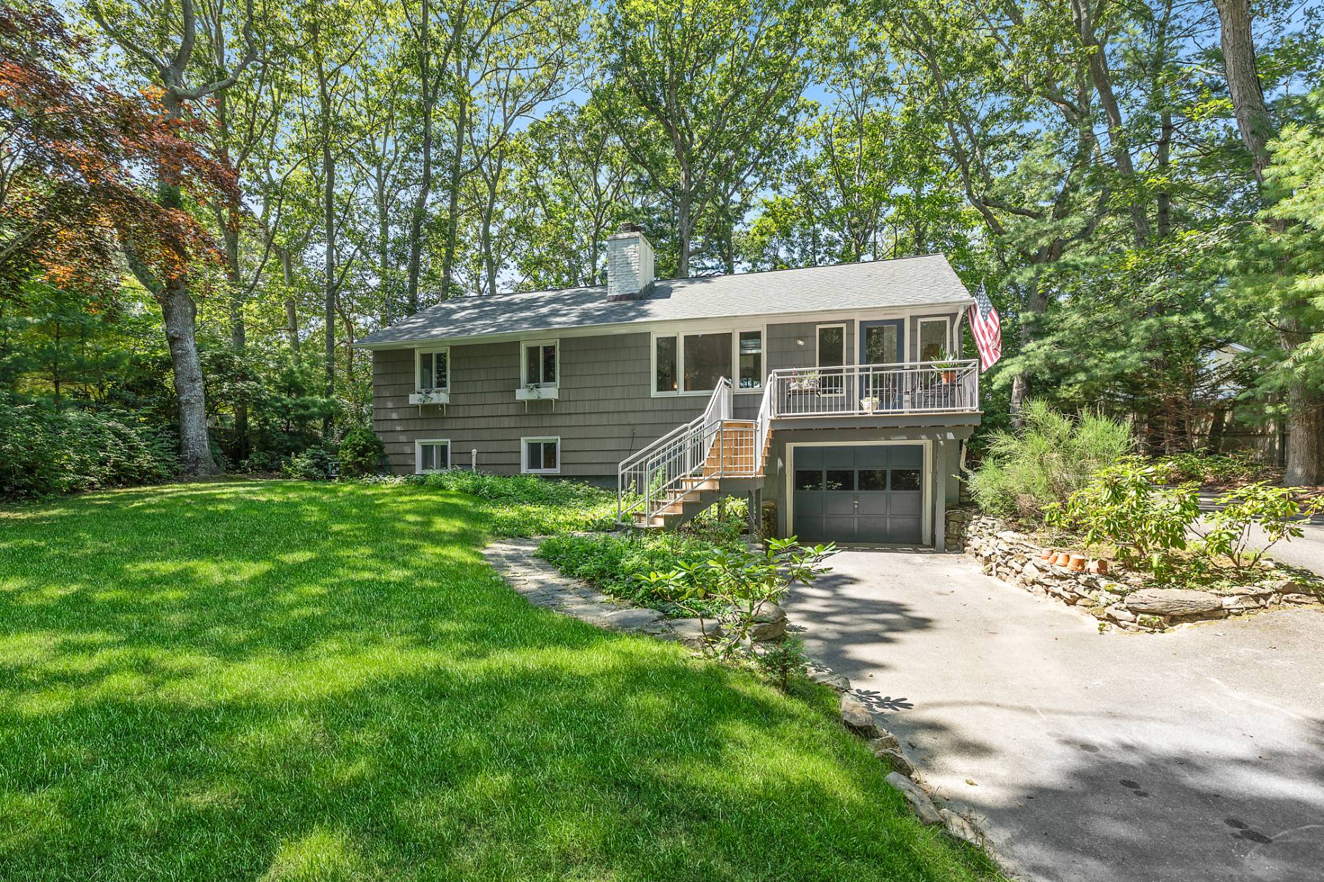 a front view of a house with a garden