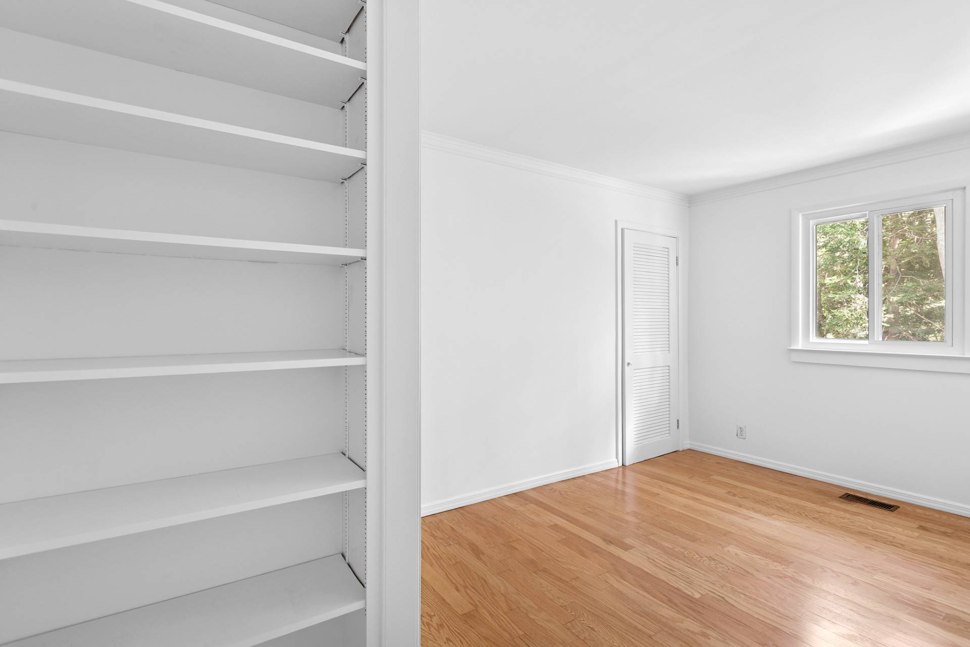 803 Noyack Road Southampton, NY 11968 - Photo 11 of 20 a view of empty room with shelves and wooden floor