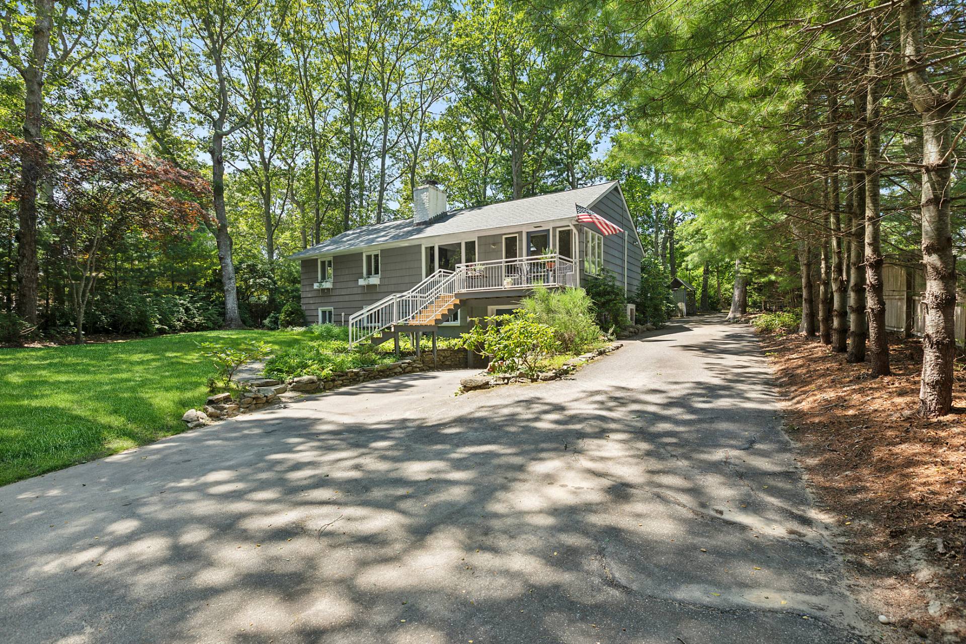 803 Noyack Road Southampton, NY 11968 - Photo 20 of 20 a front view of a house with a garden
