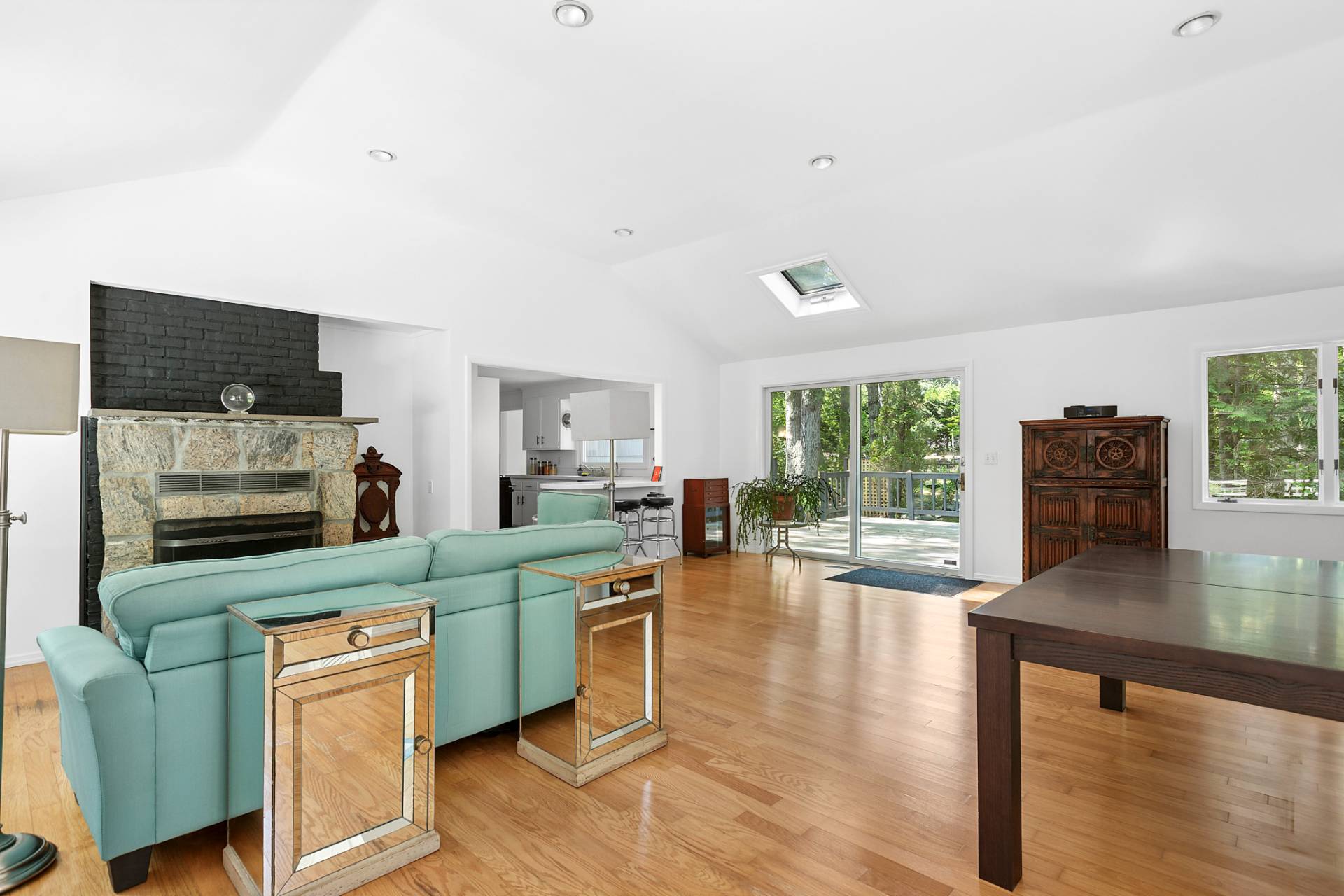 803 Noyack Road Southampton, NY 11968 - Photo 5 of 20 a kitchen with stainless steel appliances granite countertop a stove top oven a sink dishwasher and microwave with wooden floor