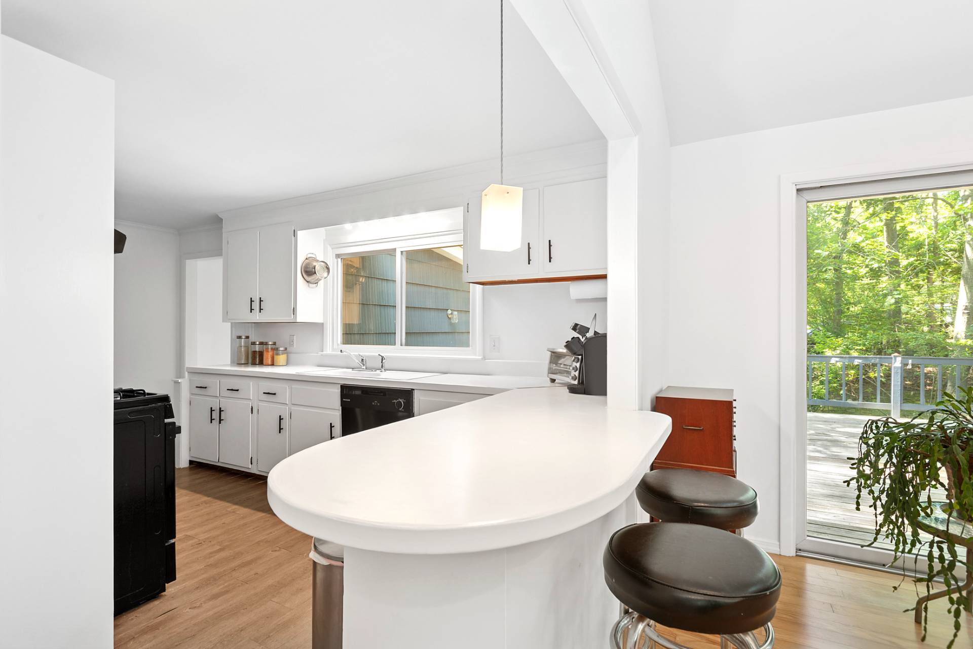 803 Noyack Road Southampton, NY 11968 - Photo 8 of 20 a kitchen with stainless steel appliances a white table and chair