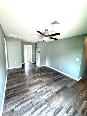a view of a room with wooden floor