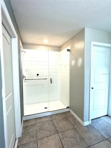 a bathroom with a glass shower door