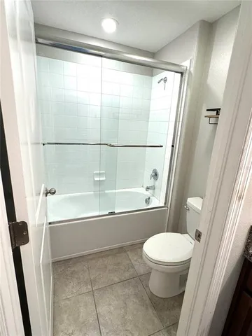 a bathroom with a toilet and a bathtub