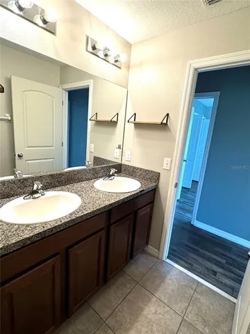 a view of a lake with a yard from a balcony