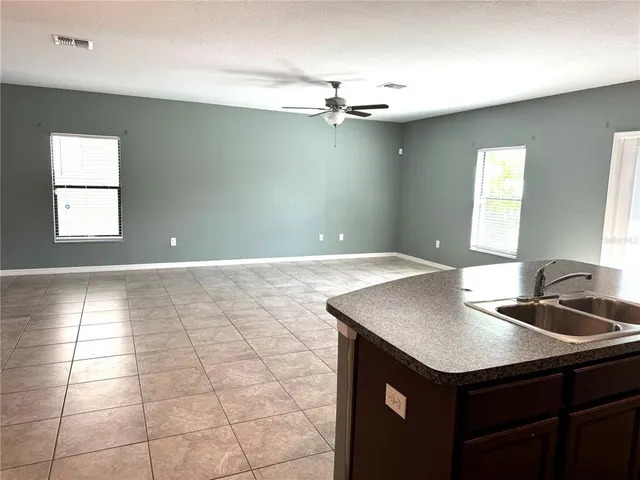 a view of a kitchen with kitchen island a sink dishwasher and fireplace