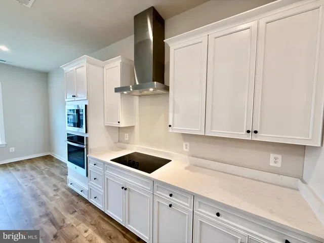 a kitchen with stainless steel appliances white cabinets and a sink