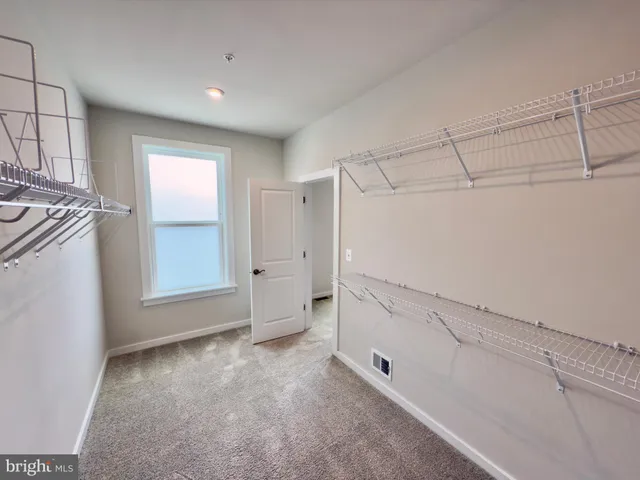 a bathroom with a granite countertop sink a mirror and a shower