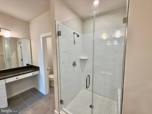 an empty room with closet and mirror