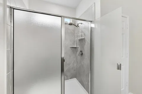a bathroom with a double vanity sink toilet and shower