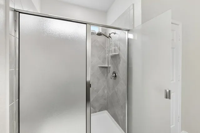a bathroom with a double vanity sink toilet and shower