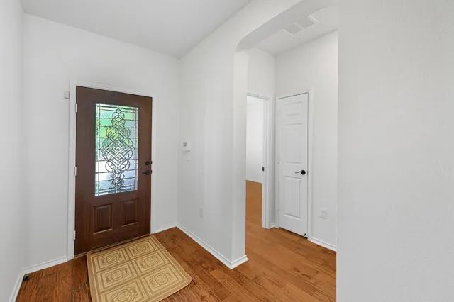 a view of a house with a small yard and wooden fence