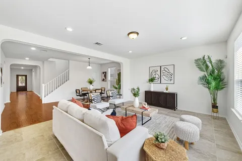 a kitchen with stainless steel appliances kitchen island granite countertop a refrigerator and cabinets