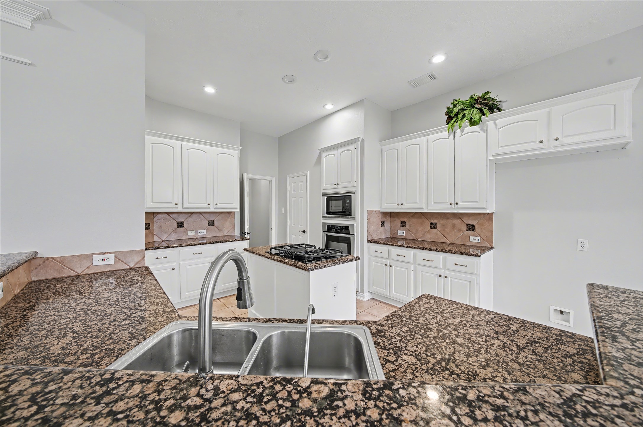 5403 Emerald Pointe Lane Sugar Land, TX 77479 - Photo 31 of 50 a kitchen with a sink a stove and cabinets