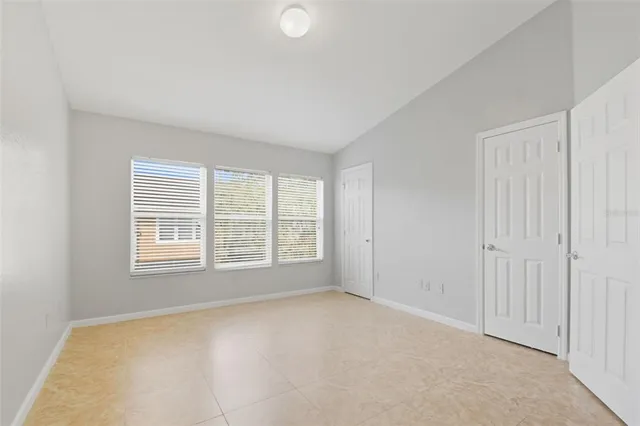 an empty room with a empty space and windows